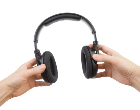 Headphones in hands on a white backgroundの写真素材