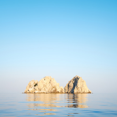 rocks in the sea on a background of clear skyの写真素材