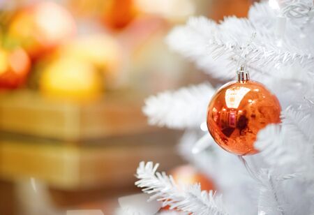 red ball hanging from a decorated Ñhristmas treeの写真素材