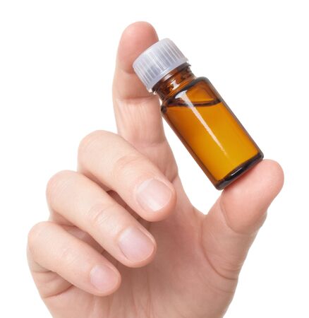 medicine bottle in hand is isolated on a white backgroundの写真素材