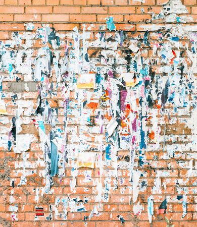 Brick wall with the remains of old advertisementsの写真素材