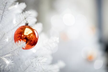 red ball hanging from a decorated Ñhristmas treeの写真素材