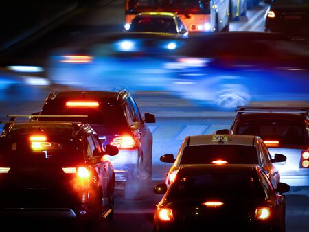 Cars at the crossroads in the darkの写真素材