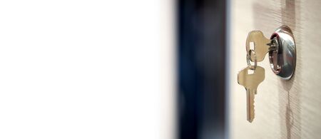 keys in the keyhole with white text fieldの写真素材