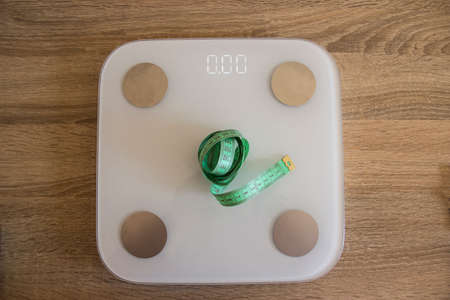 White scale with dial and measuring tape. Scales stand for people who want to measure weight and body measurements.の写真素材