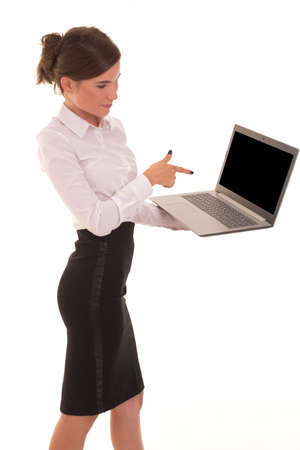 Office worker holds a laptop and points at it.の写真素材