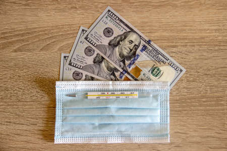 A Medical mask protects dollars from covid-19.の写真素材