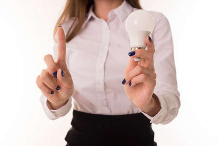 Woman with a light bulb in her hands.の写真素材