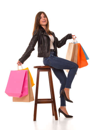 Girl sitting on a chair with purchases in hands.の写真素材