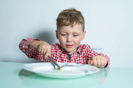 Little boy eating a small portion of food.の写真素材