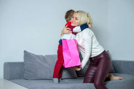 Mom hugs and thanks son for the gift.の写真素材
