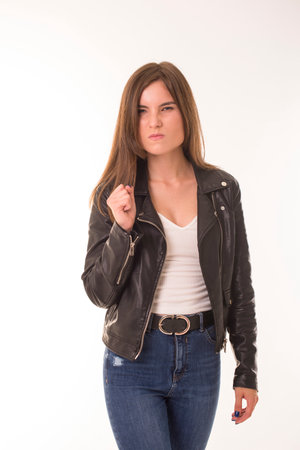 Offended girl stands on a white background.の写真素材