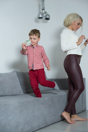 Son stole money from mom and runs away from her.の写真素材