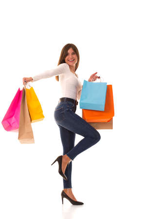 Brunette stands on white with purchases after saleの写真素材