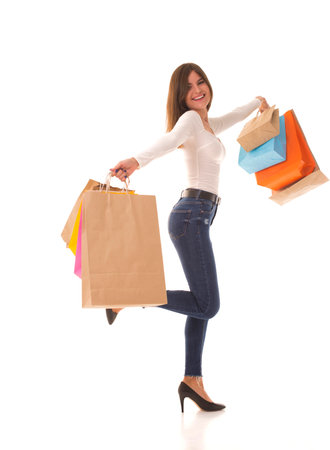 Girl in high heels stands with shopping after saleの写真素材