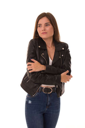 Upset girl stands on a white background and is sadの写真素材