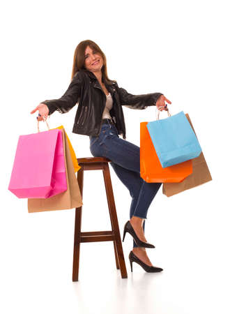 Girl after shopping looks at camera in surprise.の写真素材