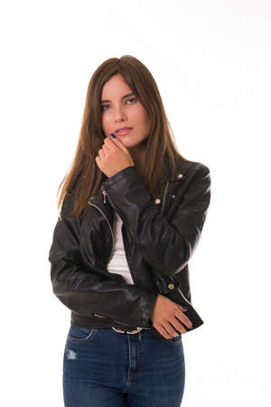 Girl with upset emotion stands on white backgroundの写真素材