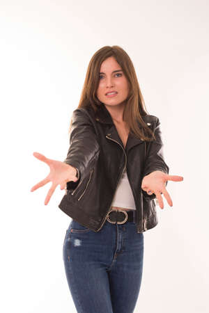 Young girl put hands forward and looks at camera.の写真素材