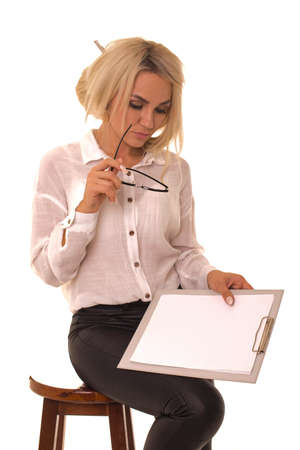 Woman sitting on a chair with a tablet in her handの写真素材