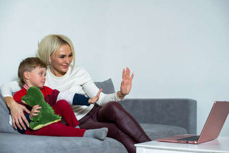Mom and son communicate on the Internet.の写真素材