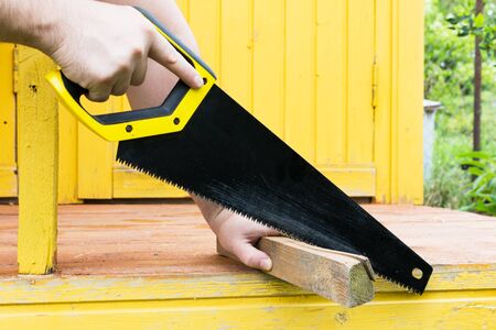 Drank in the hands of men. A man is cutting boardの写真素材