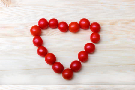small red tomatoes on a wooden boardの写真素材