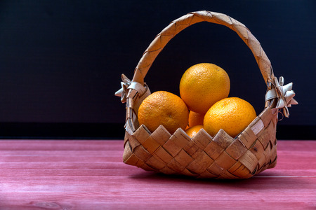 Tangerines in a wicker basketの写真素材