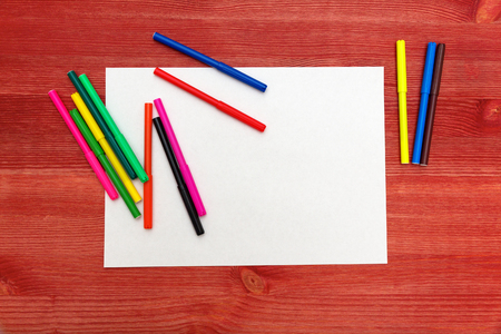 colored felt-tip pens on a wooden tableの写真素材