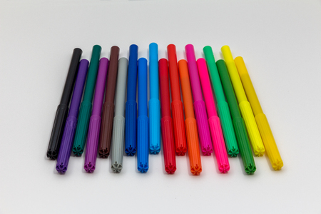 Multicolored markers on a sheet of white paperの写真素材