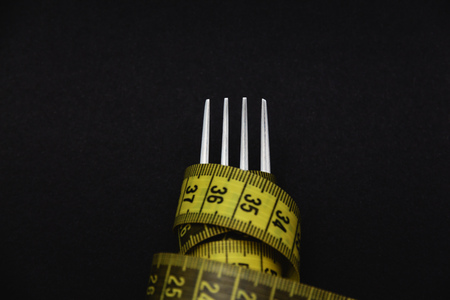 fork and centimeter tape on a dark backgroundの写真素材