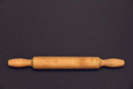 Rolling pin  on a dark background. Free space for textの写真素材