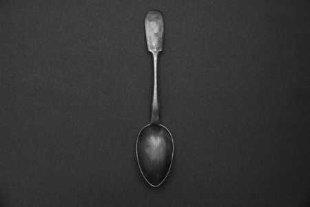 old tea spoon on a dark backgroundの写真素材