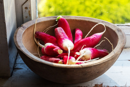 red large radish in a wooden bowlの写真素材