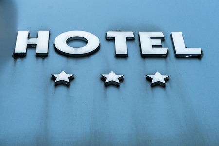 three large metal stars and the word hotelの写真素材