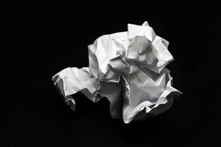 crumpled white paper on a black backgroundの写真素材