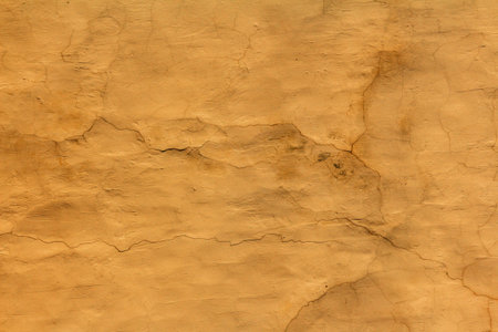 texture of old canvas of yellow color with cracks and scratches