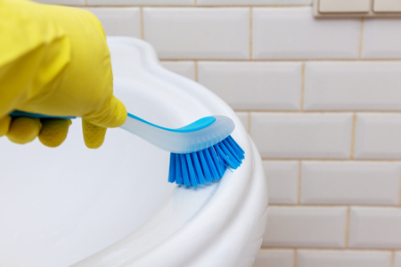 Bathroom cleaning. marble sink wash with a brushの写真素材