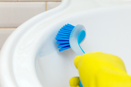 Bathroom cleaning. marble sink wash with a brushの写真素材