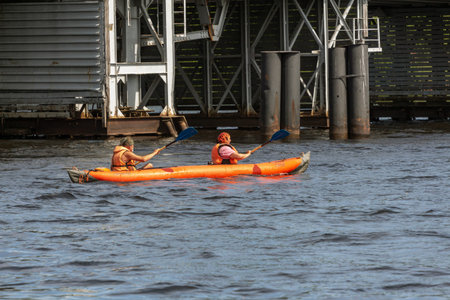 St. Petersburg, Russia, June 17, 2019: a man and a woman in life jackets are floating on an inflatable canoe along the Neva Riverのeditorial素材