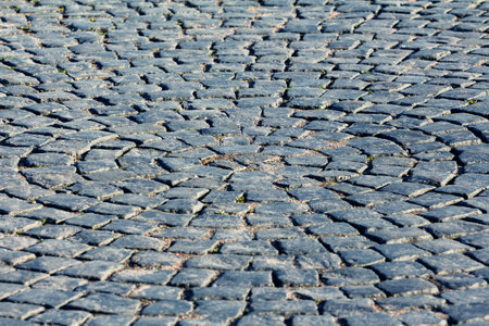 Old Paving stone, granite pavement - Shallow depth of field. abstract masonry background