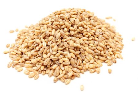 heap of seeds of golden pearl barley isolated on a white background. healthy natural food conceptの写真素材