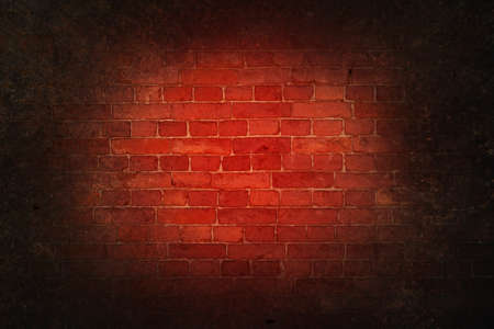 Gloomy bloody background scary red bricks of an old wall with dark vignetteの写真素材