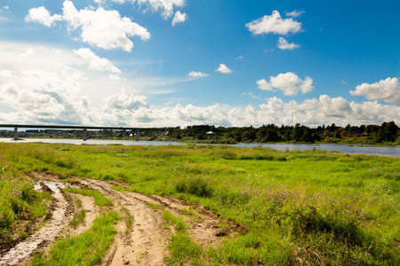 Dirt road with puddles along the Sukhona river.の写真素材