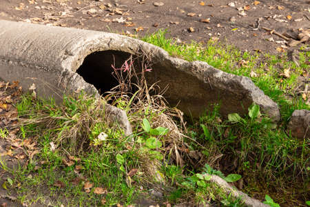 Damaged large concrete drainage pipe on a country roadの写真素材