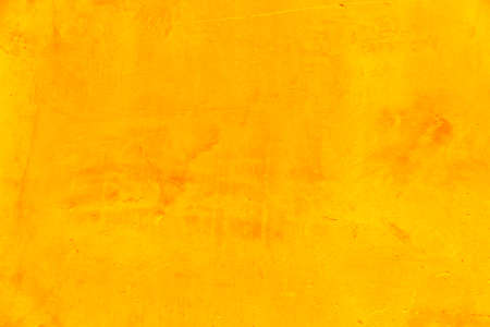 Yellow cement wall with orange gradient as background for creative ideas and textの写真素材