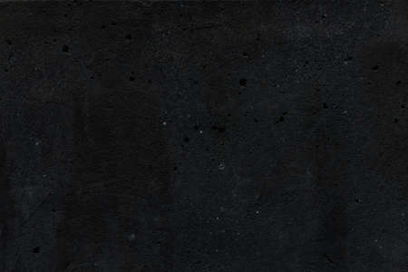 Porous texture of a gloomy black concrete wall as a background for text and design on the theme of Halloweenの写真素材