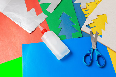Set of colored cardboard sheets with scissors and paper glue. Children's creativity to create a Christmas applicationの写真素材