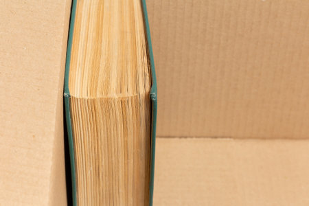 An old book with yellowed pages in a cardboard boxの写真素材