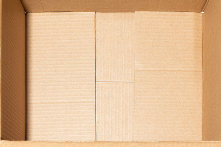 The bottom is an empty open brown cardboard box. Concept of insurance of mailings and online purchasesの写真素材